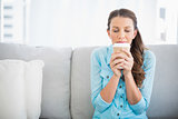 Delighted woman holding cup of coffee