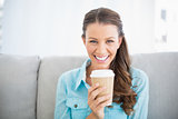 Portrait of attractive smiling woman holding cup of coffee