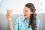 Smiling woman looking at her coffee