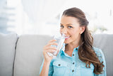 Cheerful woman holding glass of water