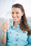 Portrait of attractive woman holding glass of water