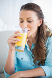 Happy woman drinking orange juice