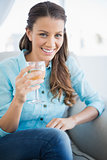 Happy woman holding glass of white wine