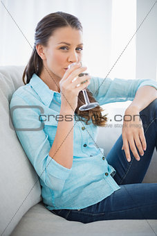 Peaceful woman drinking white wine