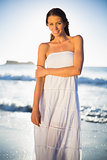 Calm woman in white summer dress posing