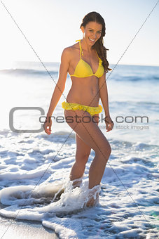 Happy gorgeous woman in yellow bikini