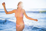 Portait of smiling woman in pink bikini posing
