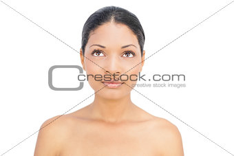 Thoughtful black haired woman posing