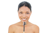 Cheerful black haired model holding eyebrow brush