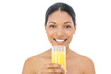 Cheerful black haired model holding glass of orange juice
