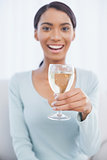 Smiling attractive woman drinking white wine