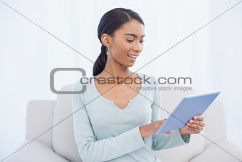 Cheerful attractive woman using her digital tablet