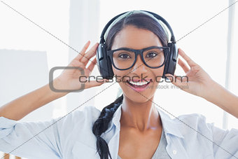 Cheerful attractive artist listening to music
