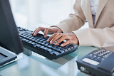 Close up on businesswoman typing on her keyboard