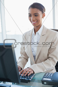 Smiling businesswoman working on her computer