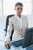 Serious attractive businesswoman working on her computer