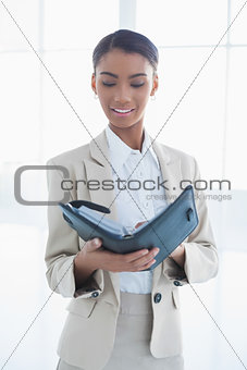 Peaceful elegant businesswoman holding her agenda
