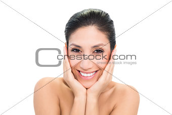 Happy brunette touching her face with both hands