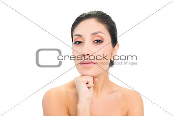 Happy brunette resting her chin on her fist