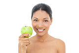 Cheerful black haired model holding green apple