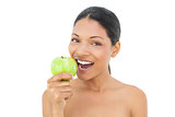 Smiling black haired model holding green apple