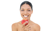 Cheerful black haired model holding red apple