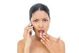 Shocked black haired model on the phone