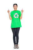 Cheerful black haired model wearing recycling tshirt giving thumbs up