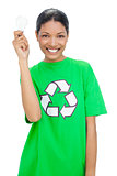 Happy model wearing recycling tshirt holding light bulb