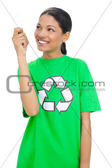 Cheerful model wearing recycling tshirt holding light bulb