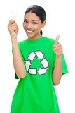 Smiling model wearing recycling tshirt holding light bulb