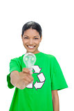 Smiling model wearing recycling tshirt holding light bulb