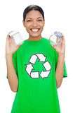 Cheerful model wearing recycling tshirt holding pots