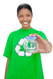 Cheerful model wearing recycling tshirt holding pot
