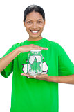 Cheerful model wearing recycling tshirt holding glass pot