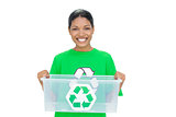 Cheerful model wearing recycling tshirt holding plastic box