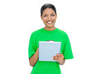 Cheerful model wearing recycling tshirt holding tablet