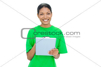 Cheerful model wearing recycling tshirt holding tablet