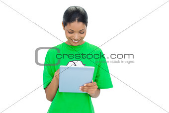 Smiling model wearing recycling tshirt holding tablet