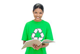Smiling model wearing recycling tshirt holding notebook