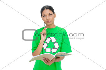 Thoughtful model wearing recycling tshirt holding notebook
