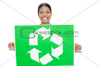 Smiling model holding recycling sign