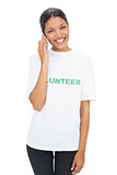 Happy model wearing volunteer tshirt having a phone call