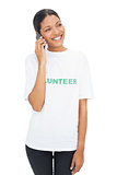 Smiling model wearing volunteer tshirt having a phone call
