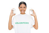 Smiling model wearing volunteer tshirt holding pots