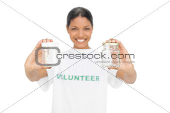 Cheerful model wearing volunteer tshirt holding pots