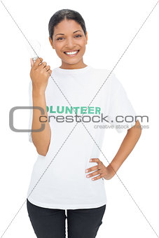Happy model wearing volunteer tshirt holding light bulb