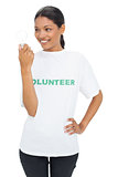 Smiling model wearing volunteer tshirt holding light bulb
