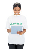 Smiling model wearing volunteer tshirt holding tablet