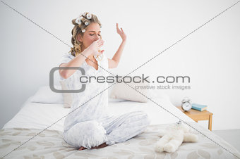 Gorgeous blonde yawning on cosy bed